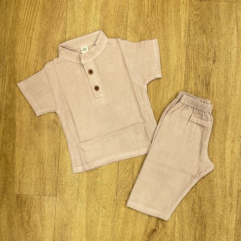 This image features is beige muslin co-ord set, consisting of a short-sleeve shirt and matching shorts.