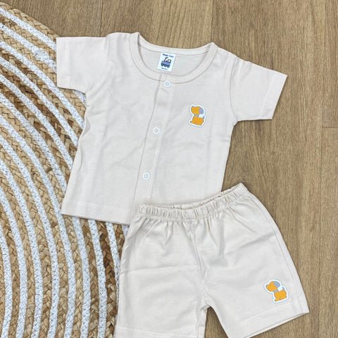 The item in the image is an (Magic train)Unisex Cotton Plain Baby Short Sleeves Suit & Short Pants. The small logo on both the shirt and shorts is a dog.