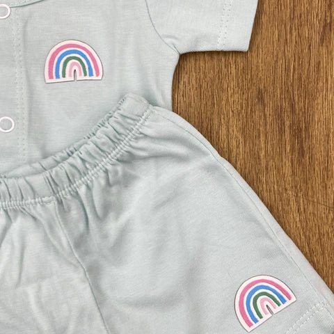 The item in the image is an (Magic train)Unisex Cotton Plain Baby Short Sleeves Suit & Short Pants. The small logo on both the shirt and shorts is a rainbow.
